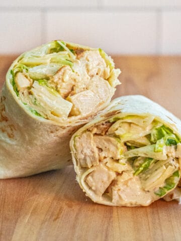 a wrap halved with chicken and lettuce.