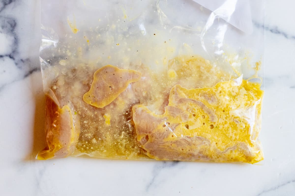 a bag of raw chicken with marinade.