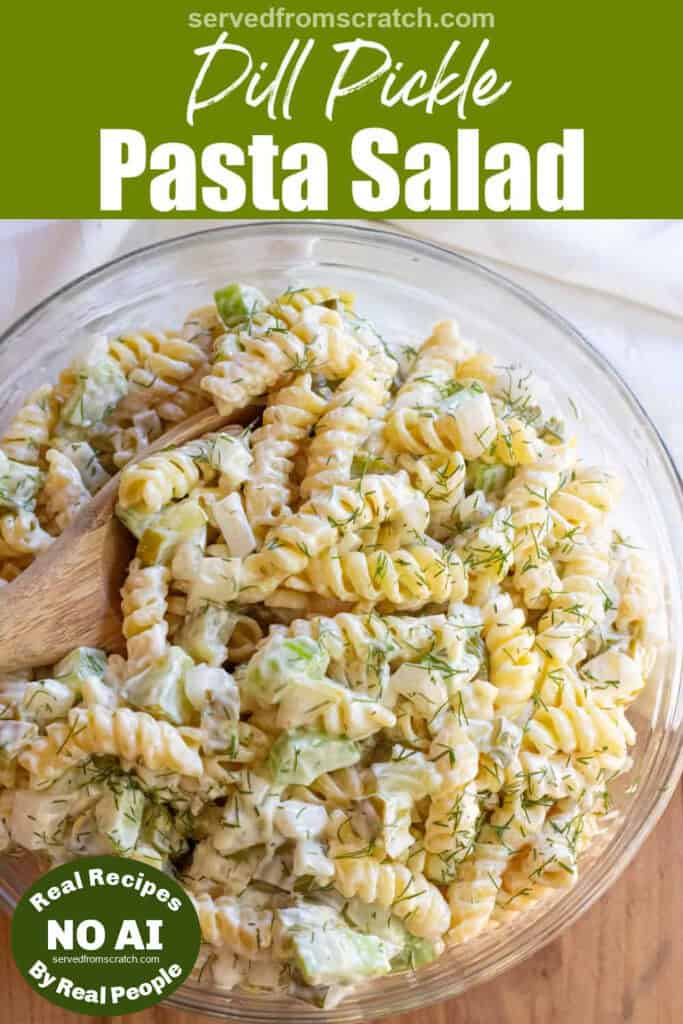 an overhead bowl of rotini pasta salad with celery and dill pickle and a wooden spoon with Pinterest pin text with NO AI sticker.