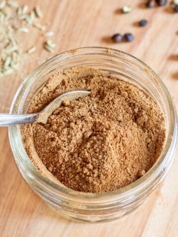 a small mason jar of chai spice with a little spoon.