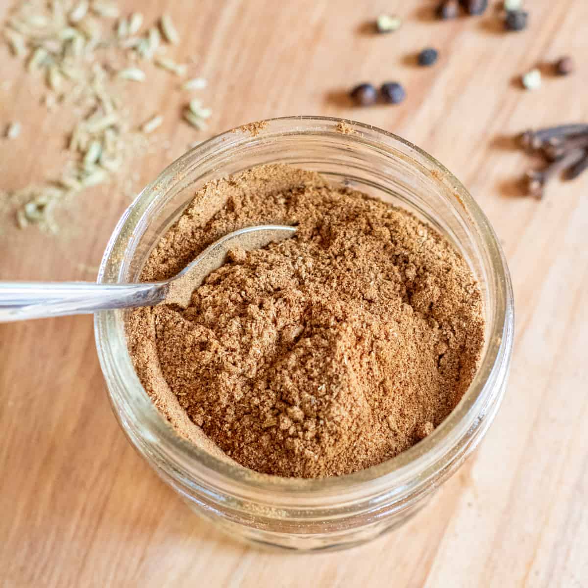 a small mason jar of chai with a little spoon.