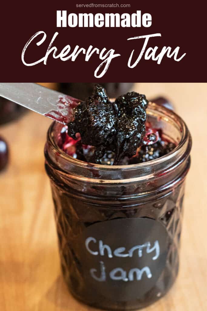 an open jar of labeled cherry jam with a knife taking some out with Pinterest pin text.