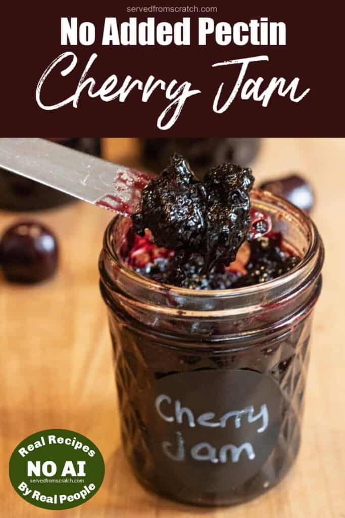 an open jar of cheery jam that is labeled and has a knife in it and with Pinterest pin text and NO AI sticker.