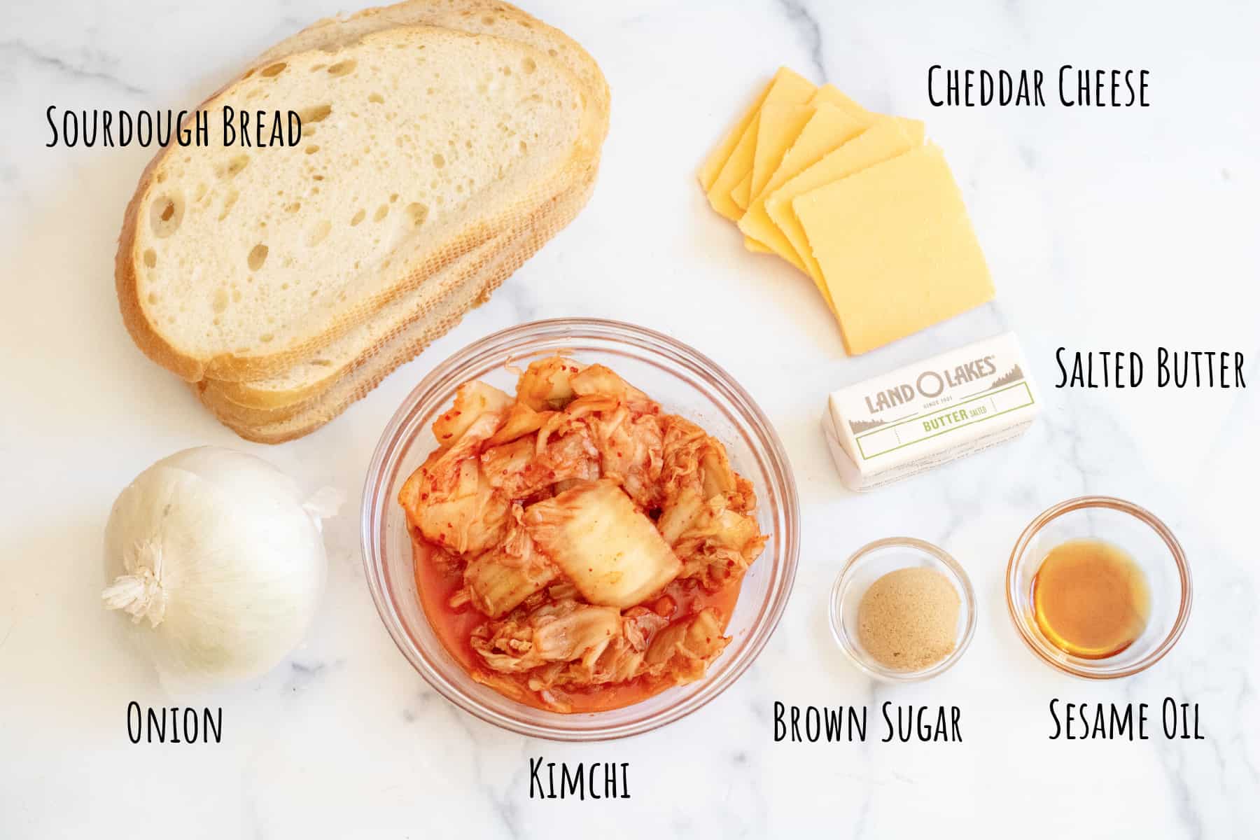 slices of bread, cheese, kimchi, onion, brown sugar, oil, and butter.