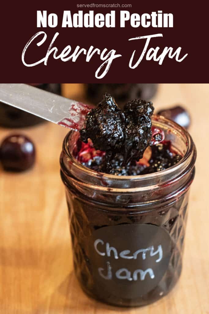 an open jar of labeled cherry jam with a knife taking some out with Pinterest pin text.