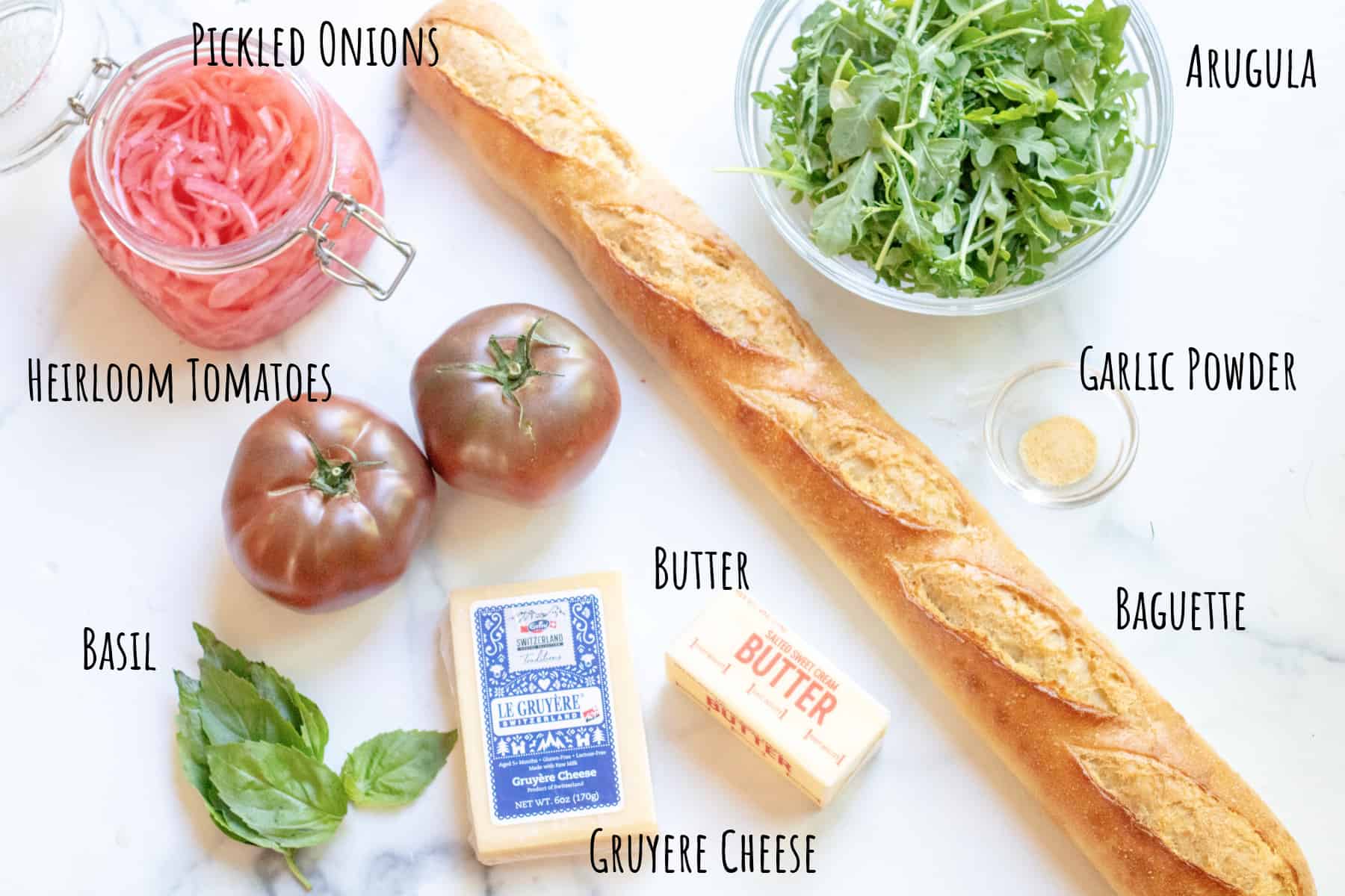 baguette, tomatoes, onions, arugula, basil, gruyere, butter, and garlic.