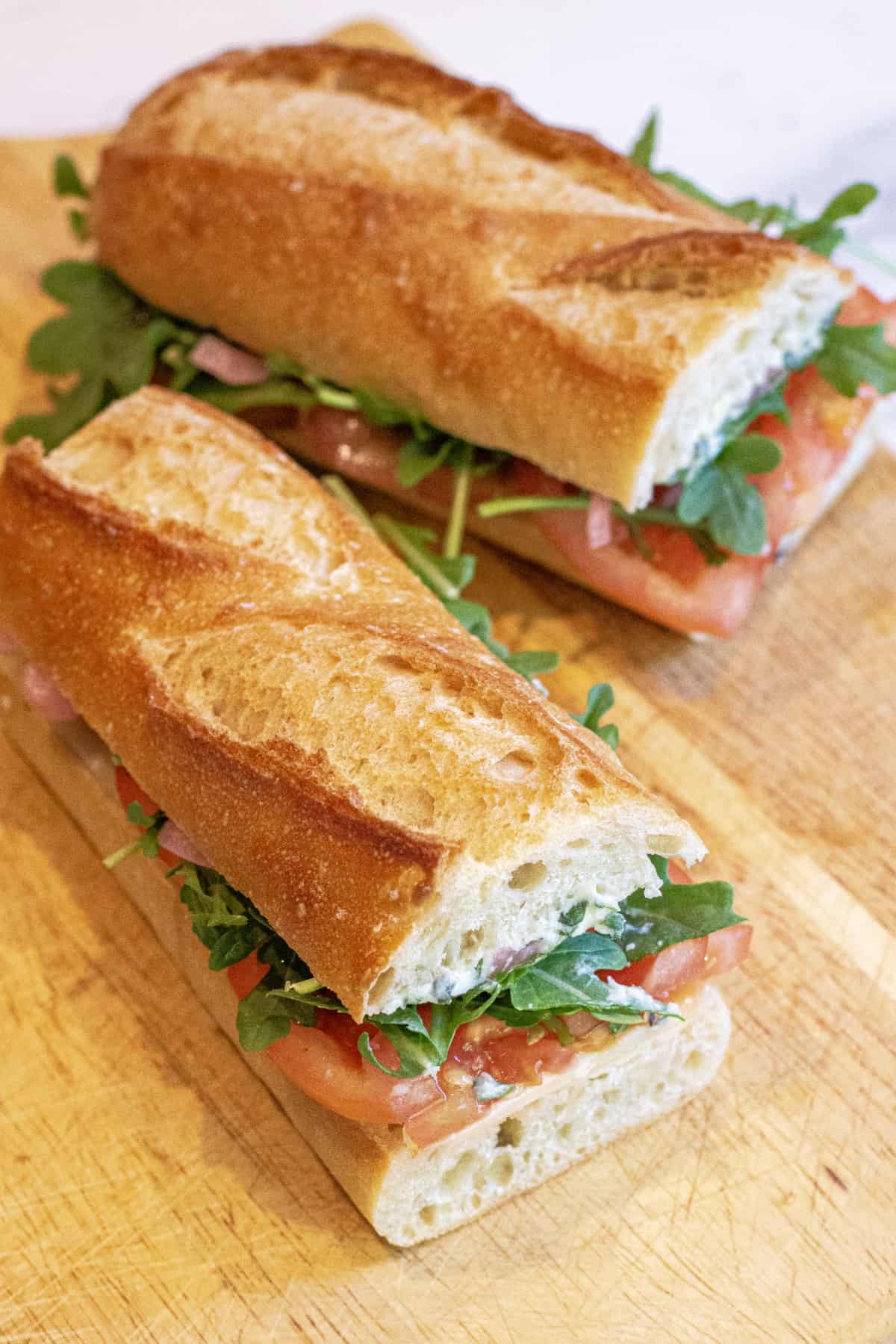 baguette sandwiches with tomatoes, arugula.