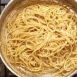 a pan with cooked spaghetti and pepper.