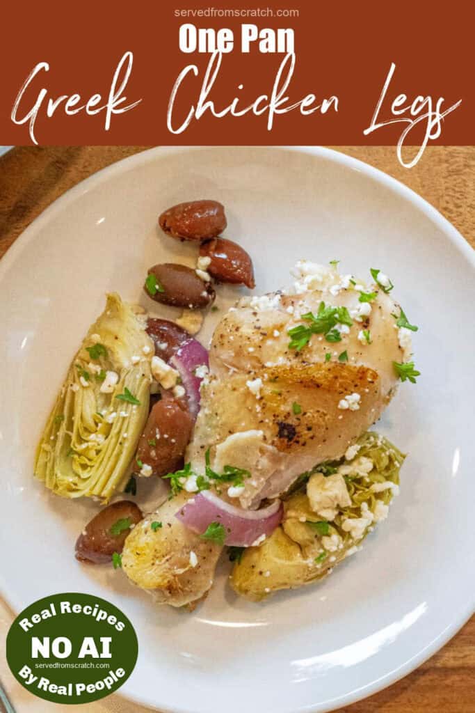 a plate with a cooked chicken leg and olive and onions, artichokes, and feta with Pinterest pin text with NO AI sticker.