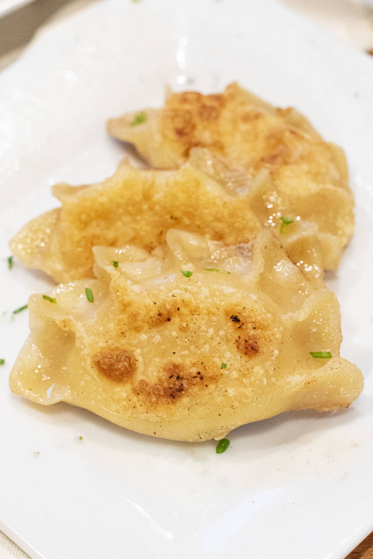a plate of crispy pierogis.