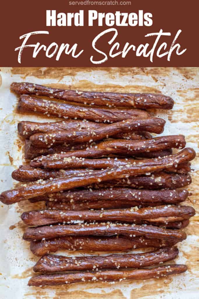 baked and salted pretzel rods on parchment paper with Pinterest pin text.