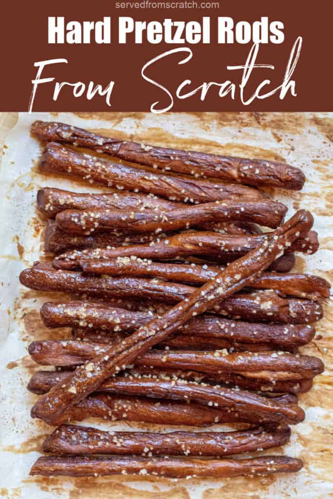 baked and salted pretzel rods on parchment paper with Pinterest pin text.