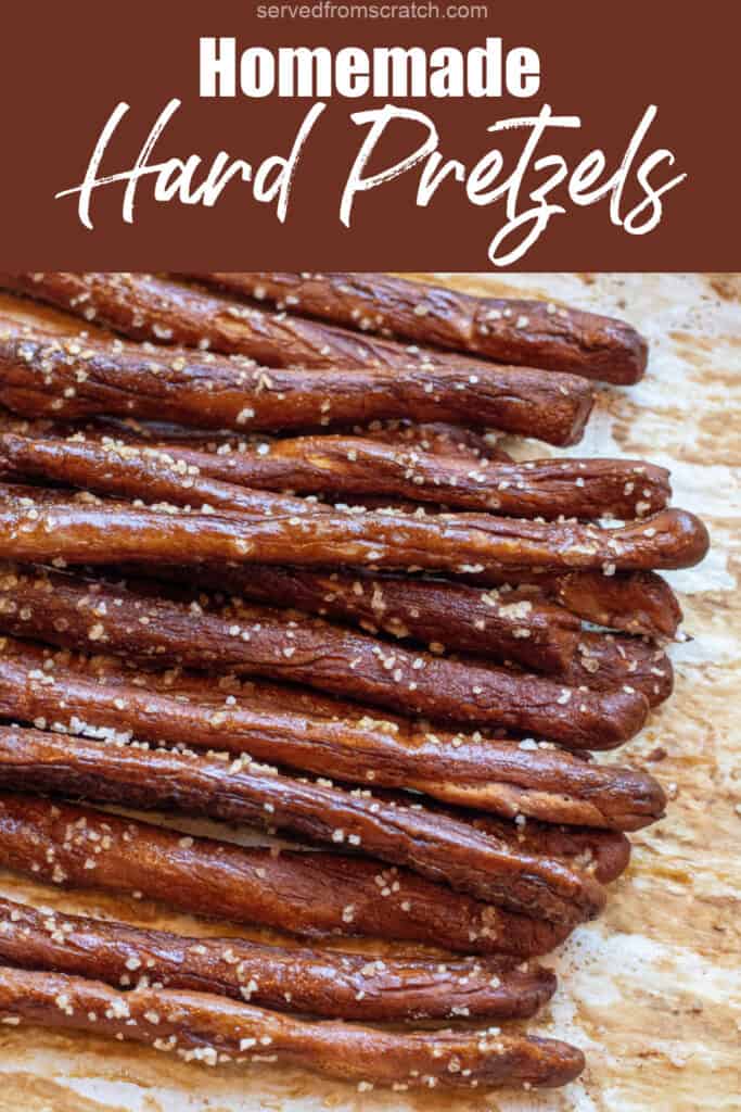baked and salted pretzel rods on parchment paper with Pinterest pin text.