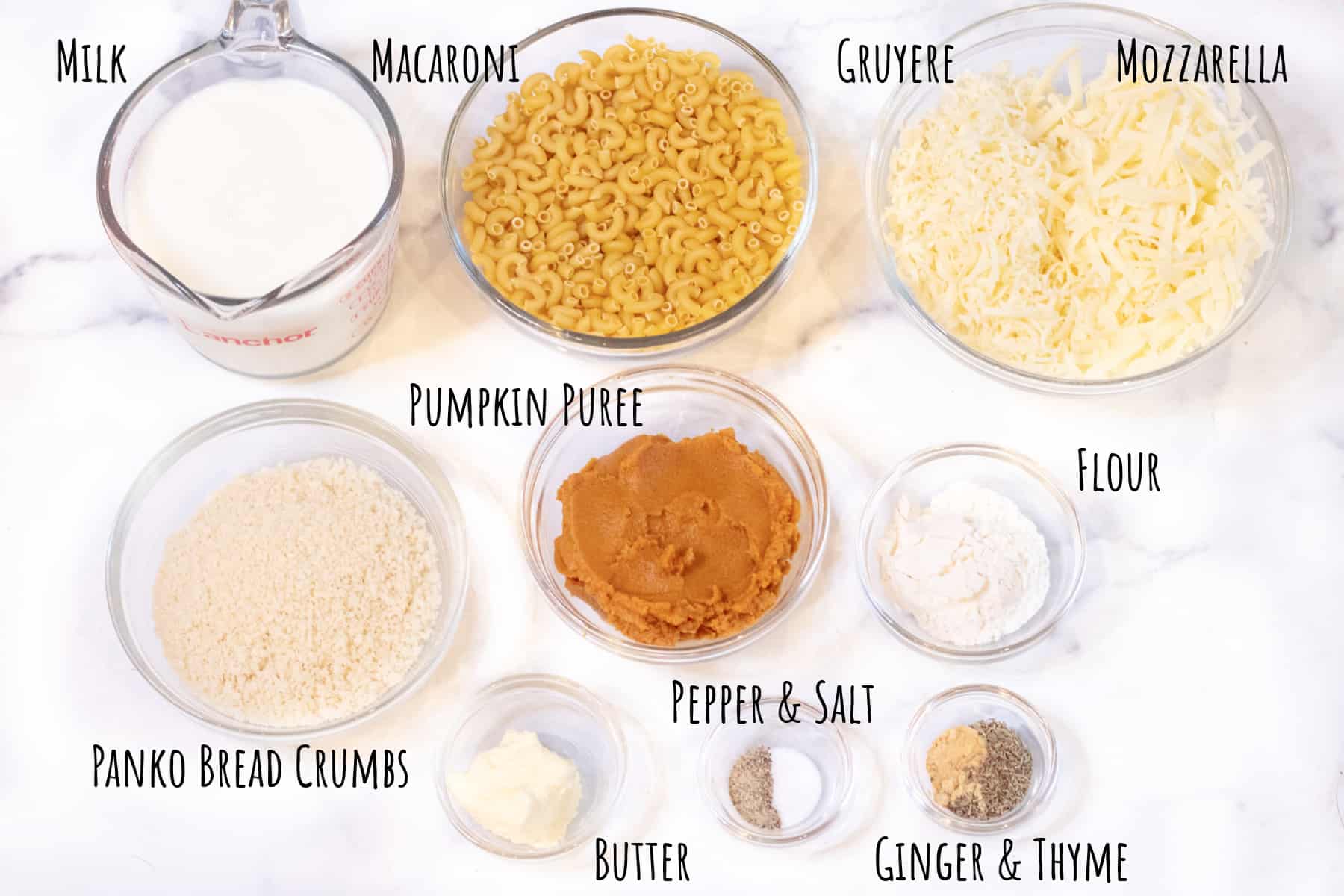 milk, macaroni, cheeses, butter, panko, pumpkin puree, spices, and butter in bowls.