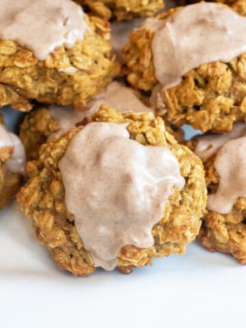 a plate of oatmeal cookies with icing.