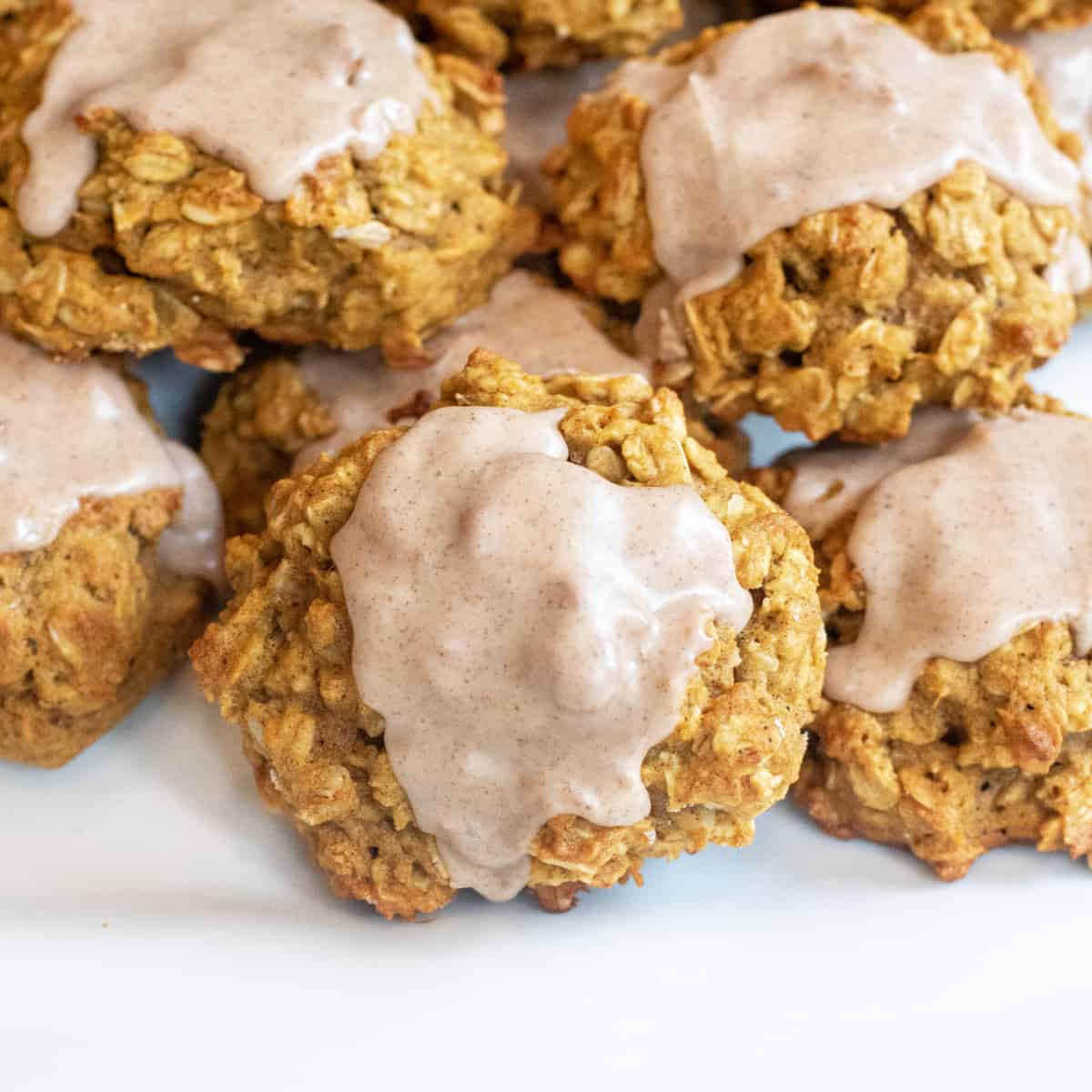 a plate of oatmeal cookies with icing.