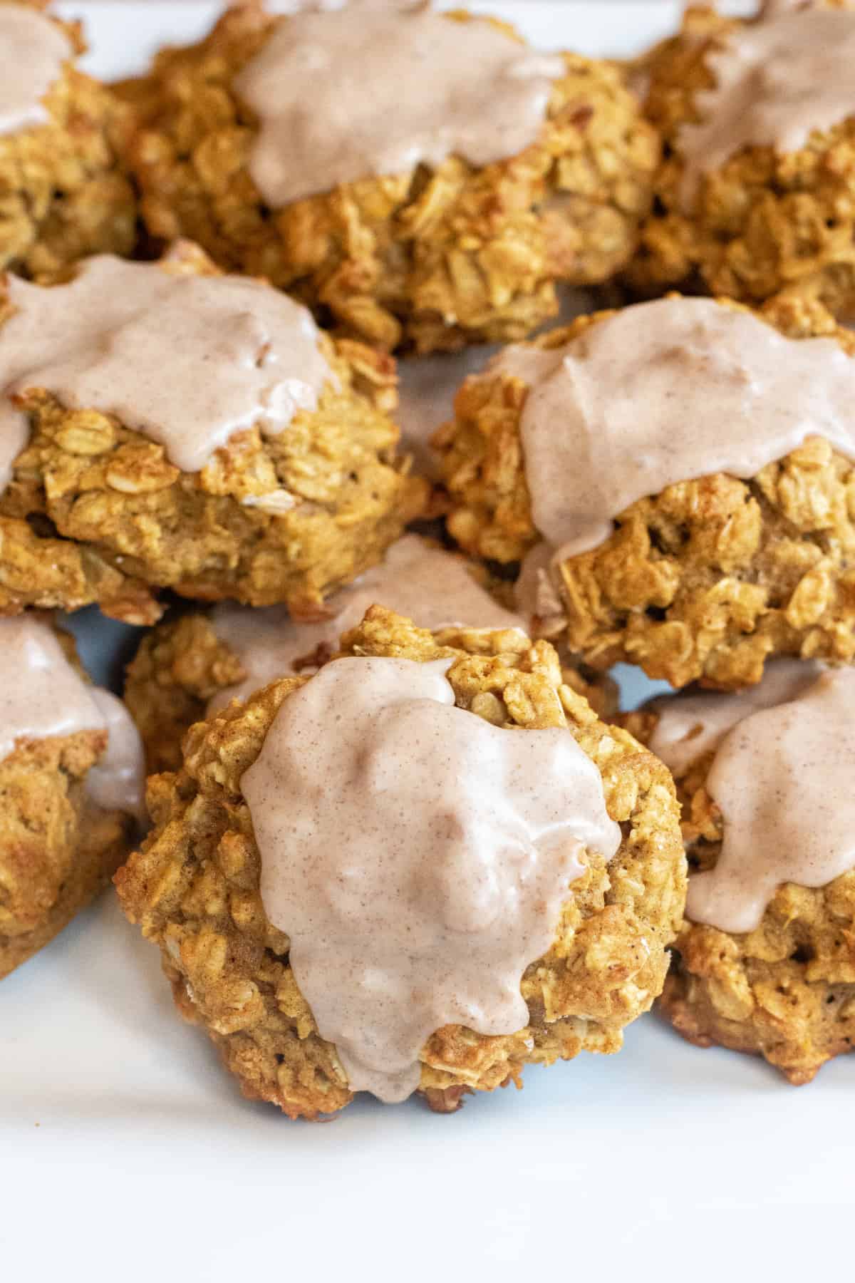 a plate of oatmeal cookies with icing.