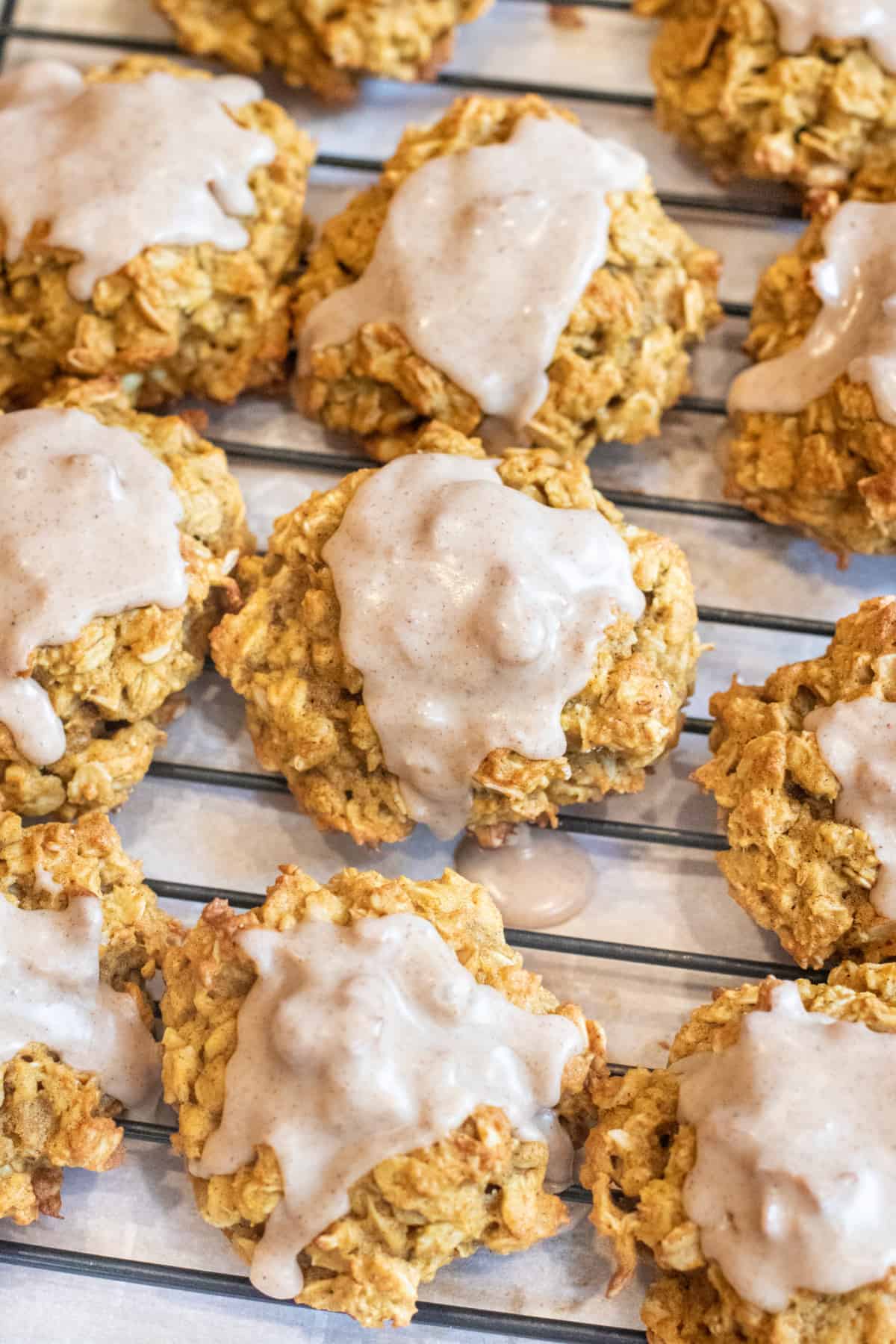 a plate of oatmeal cookies with icing.