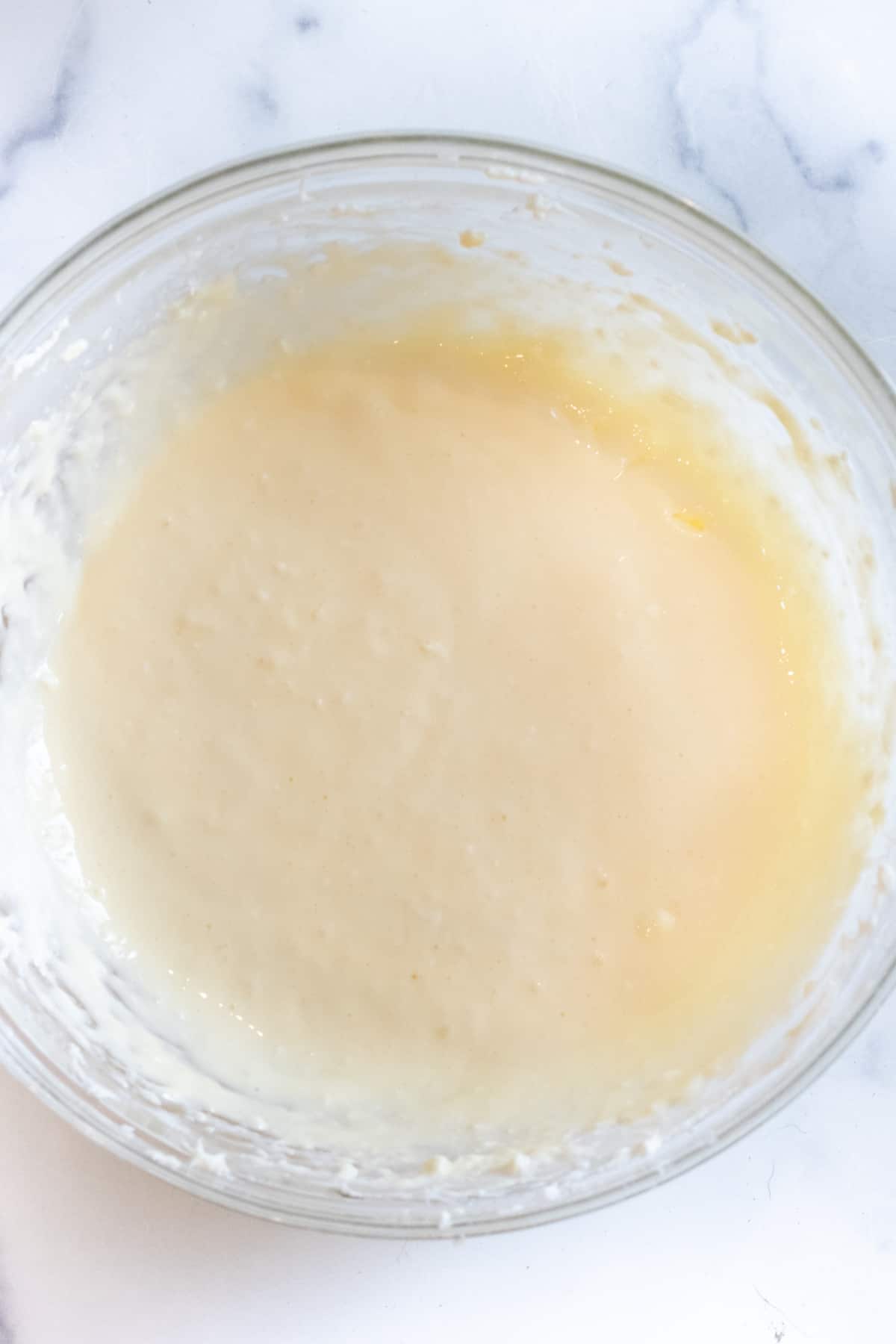 a bowl of whipped cream cheese, sugar, and egg.