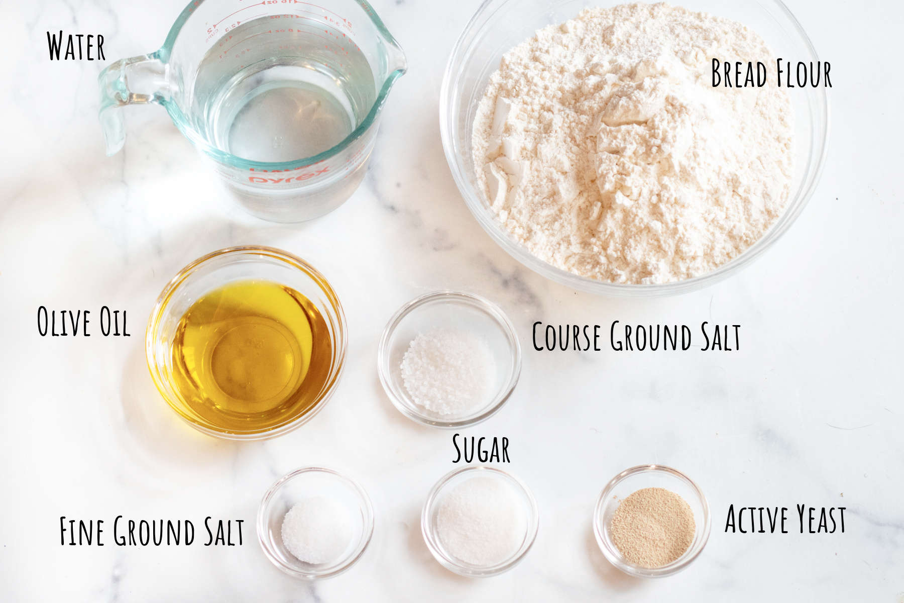 bowls of flour, oil, yeast, salts, sugar, and water.