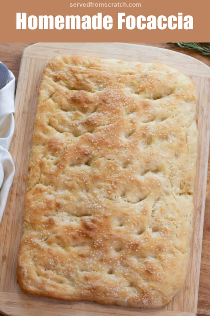 an overhead of a baked focaccia on a cutting board Pinterest pin text.