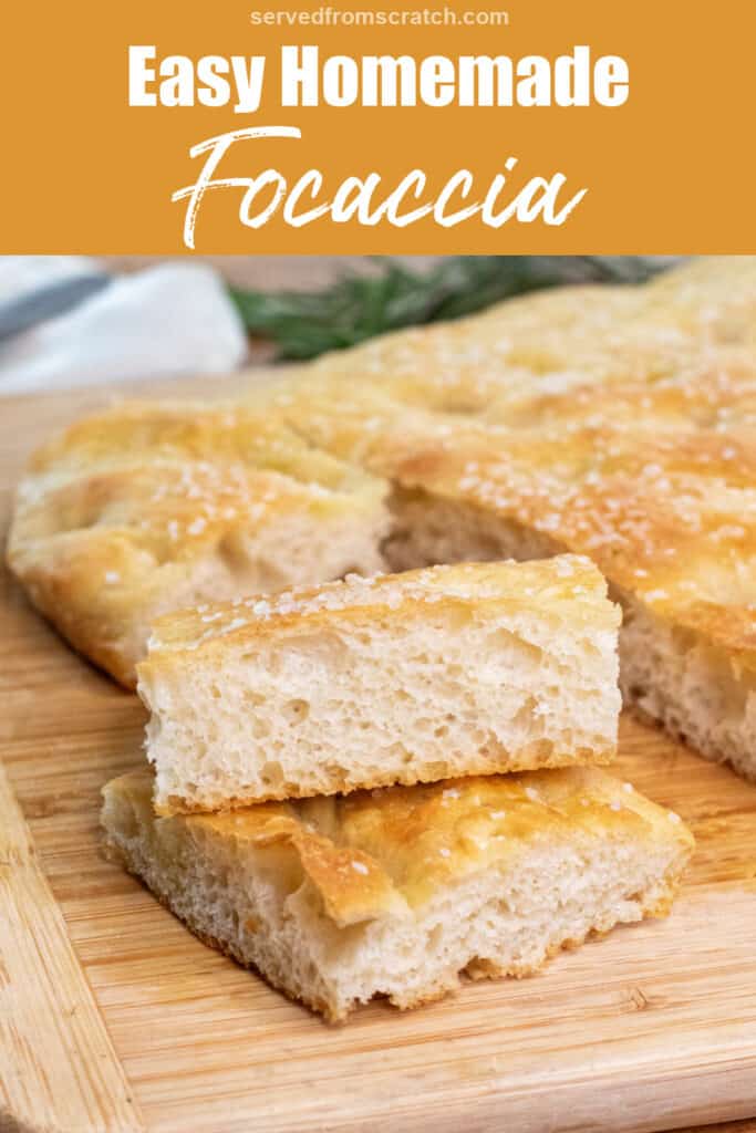 two pieces of stacked cut focaccia on a cutting board with the loaf with Pinterest pin text.
