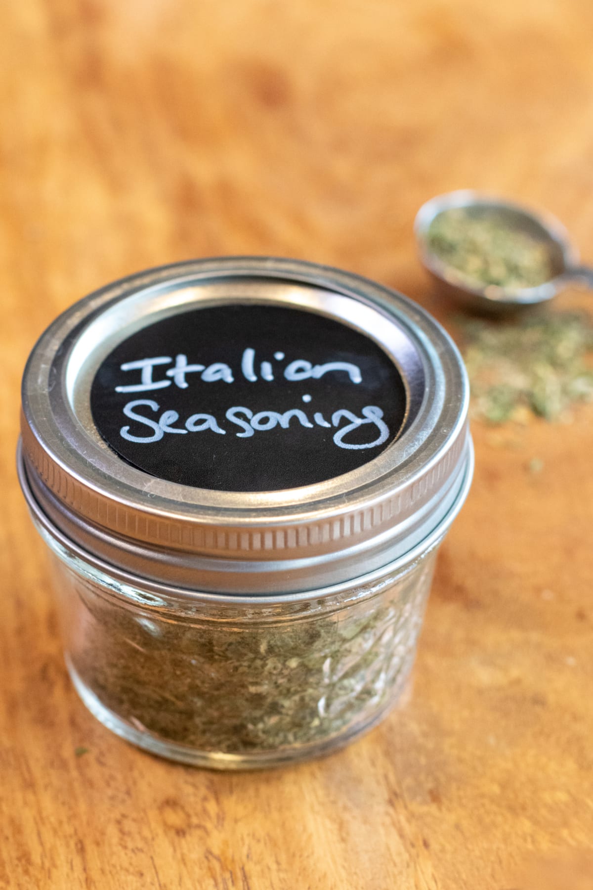 a closed mason jar labeled with Italian seasoning.