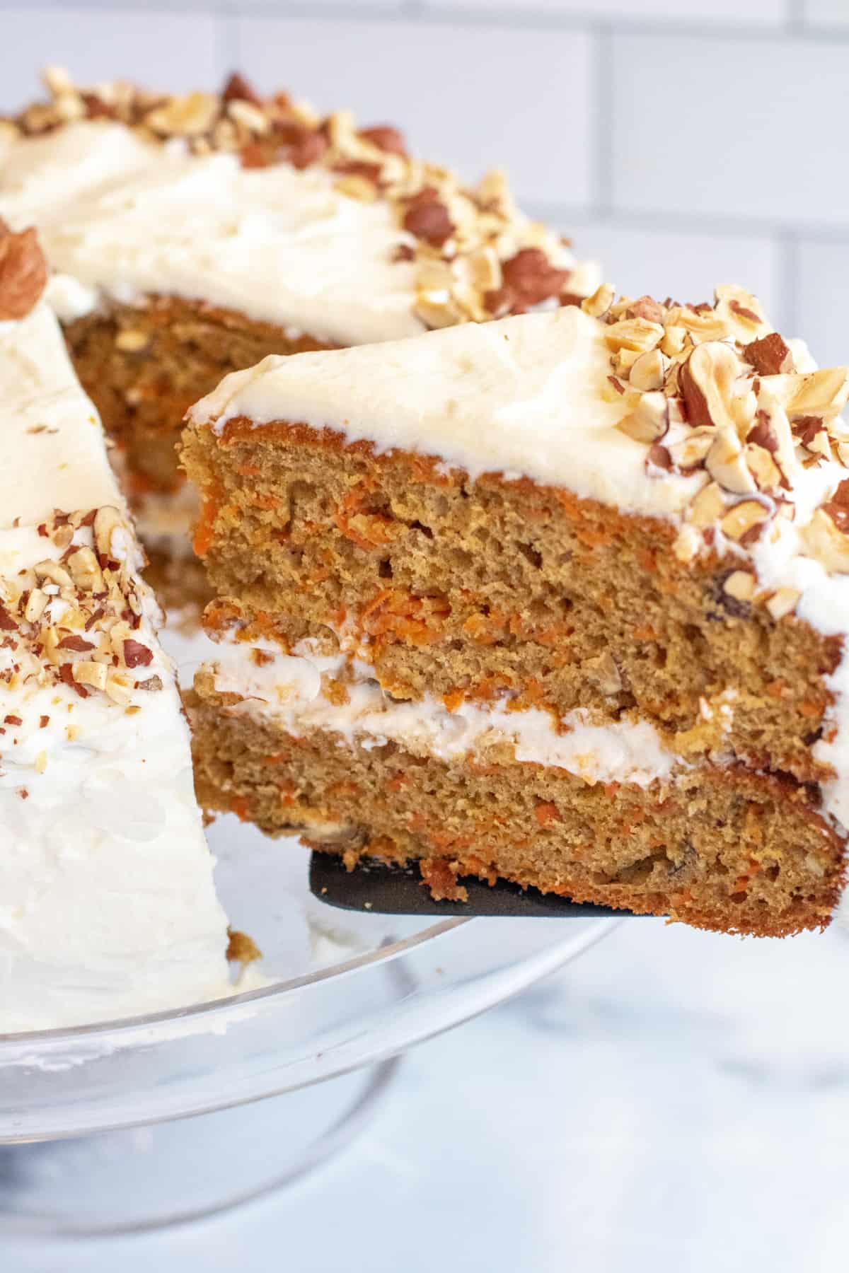 a slice of carrot cake coming out of a cake.