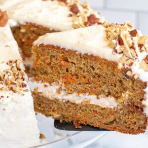 a slice of carrot cake coming out of a cake.