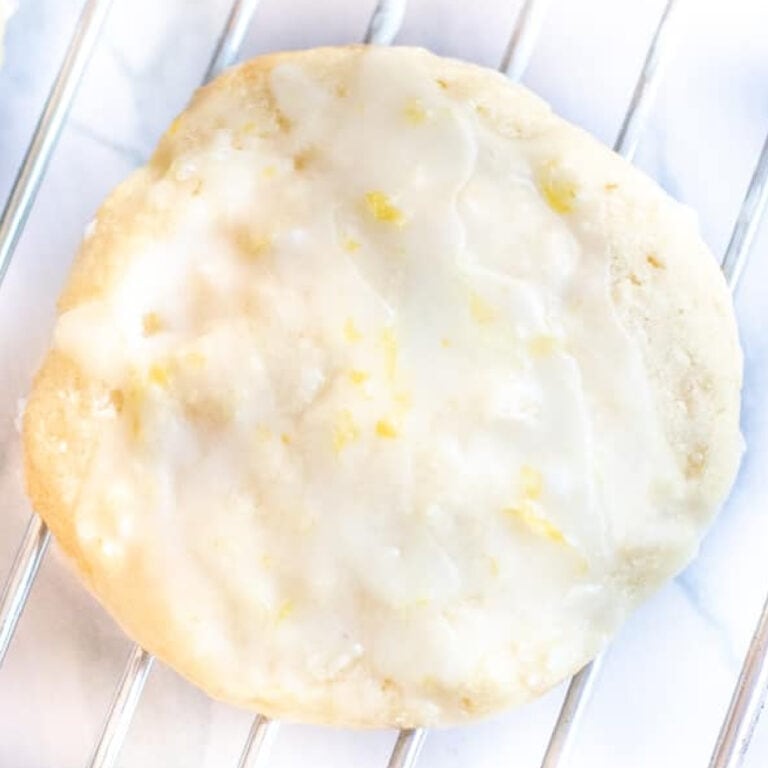 a picture of a sugar cookie with icing and lemon zest.