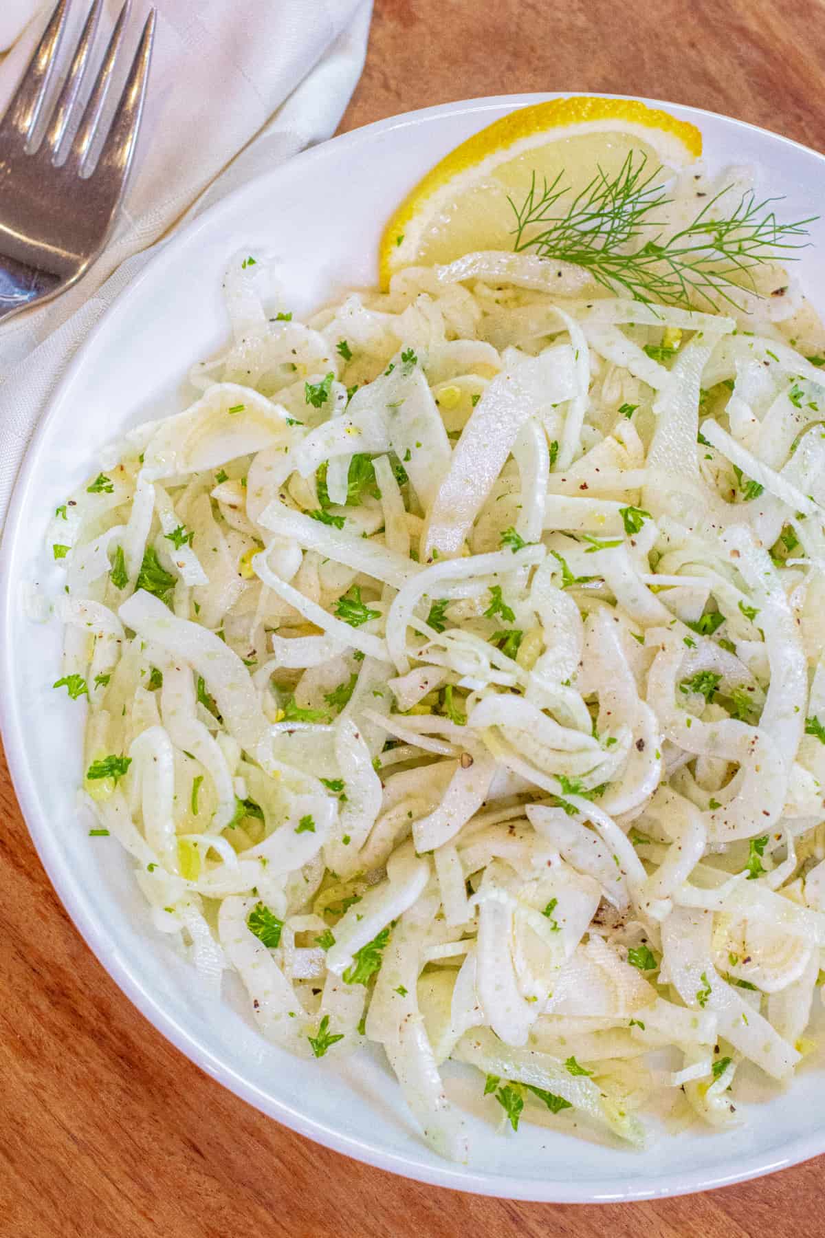an overhead of a shaved fennel salad in a bowl.