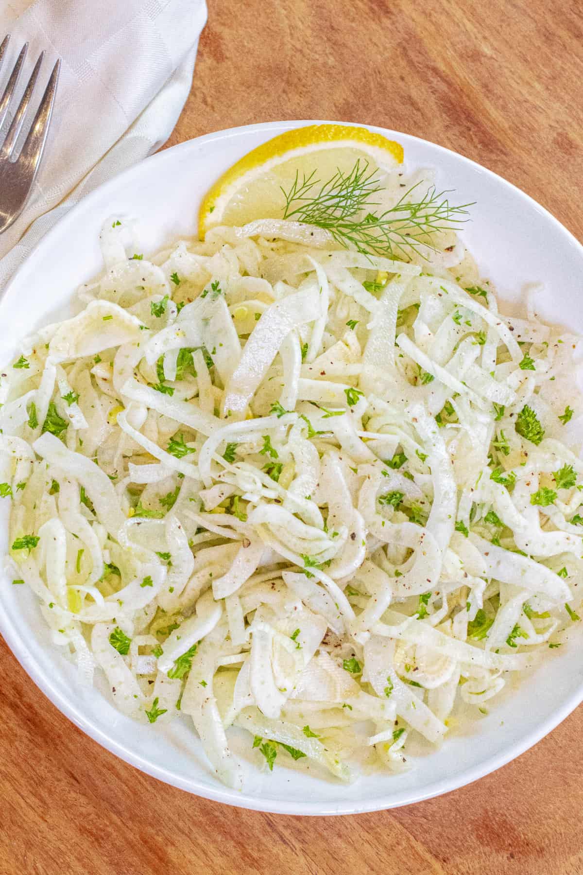 an overhead of a shaved fennel salad in a bowl.