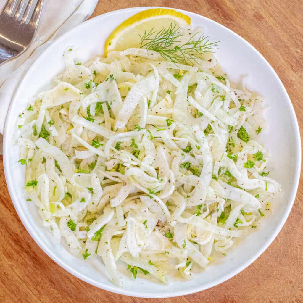 an overhead of a shaved fennel salad in a bowl.