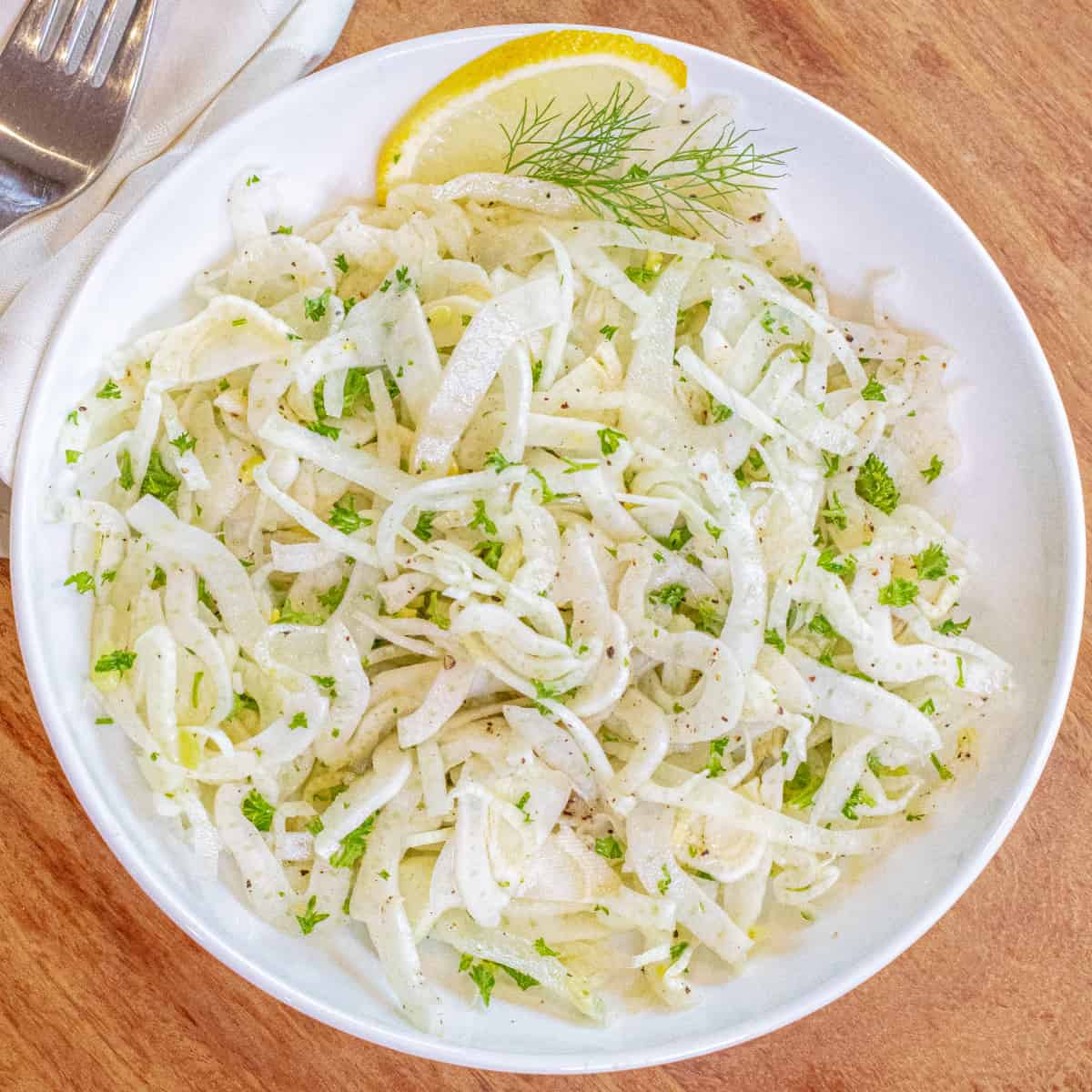 an overhead of a shaved fennel salad in a bowl. 