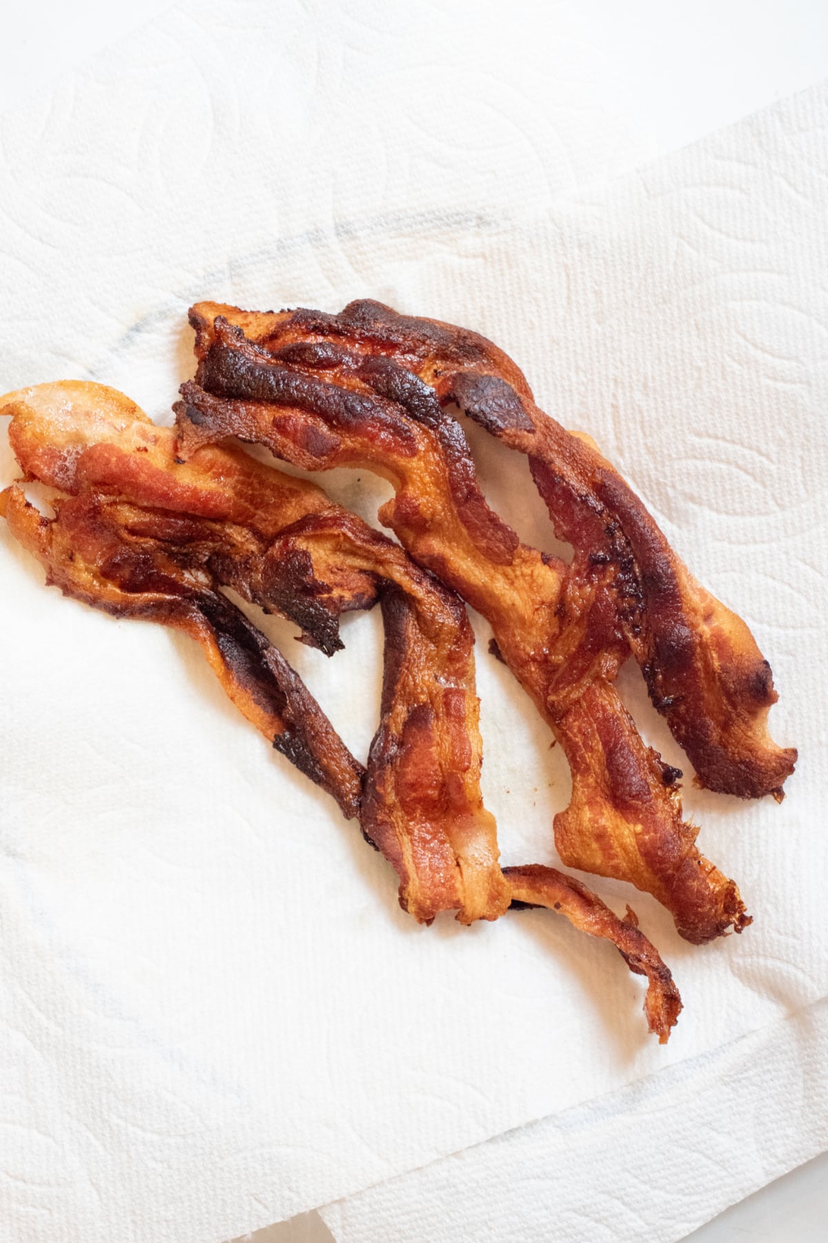 crispy cooked bacon on a paper towel.