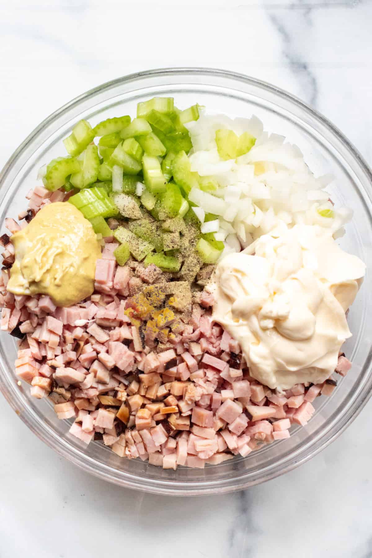 a bowl of ham, Dijon, celery, onion, mayonnaise, relish, pepper.
