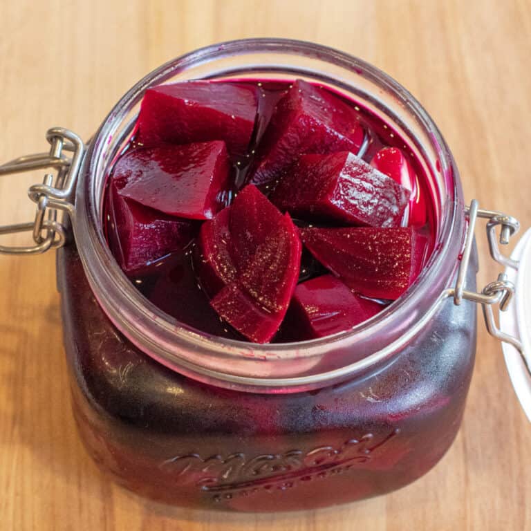 an open mason jar of pickled beets.