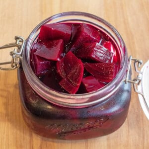 an open mason jar of pickled beets.