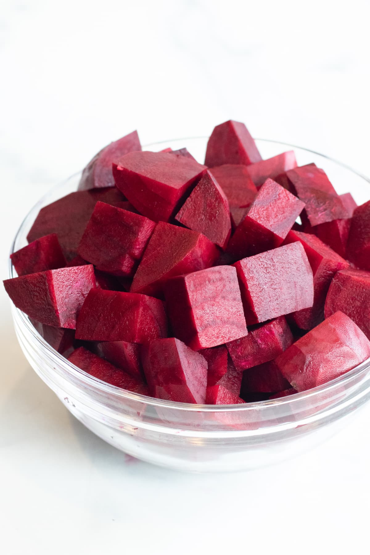 a bowl of peeled and chopped beets.