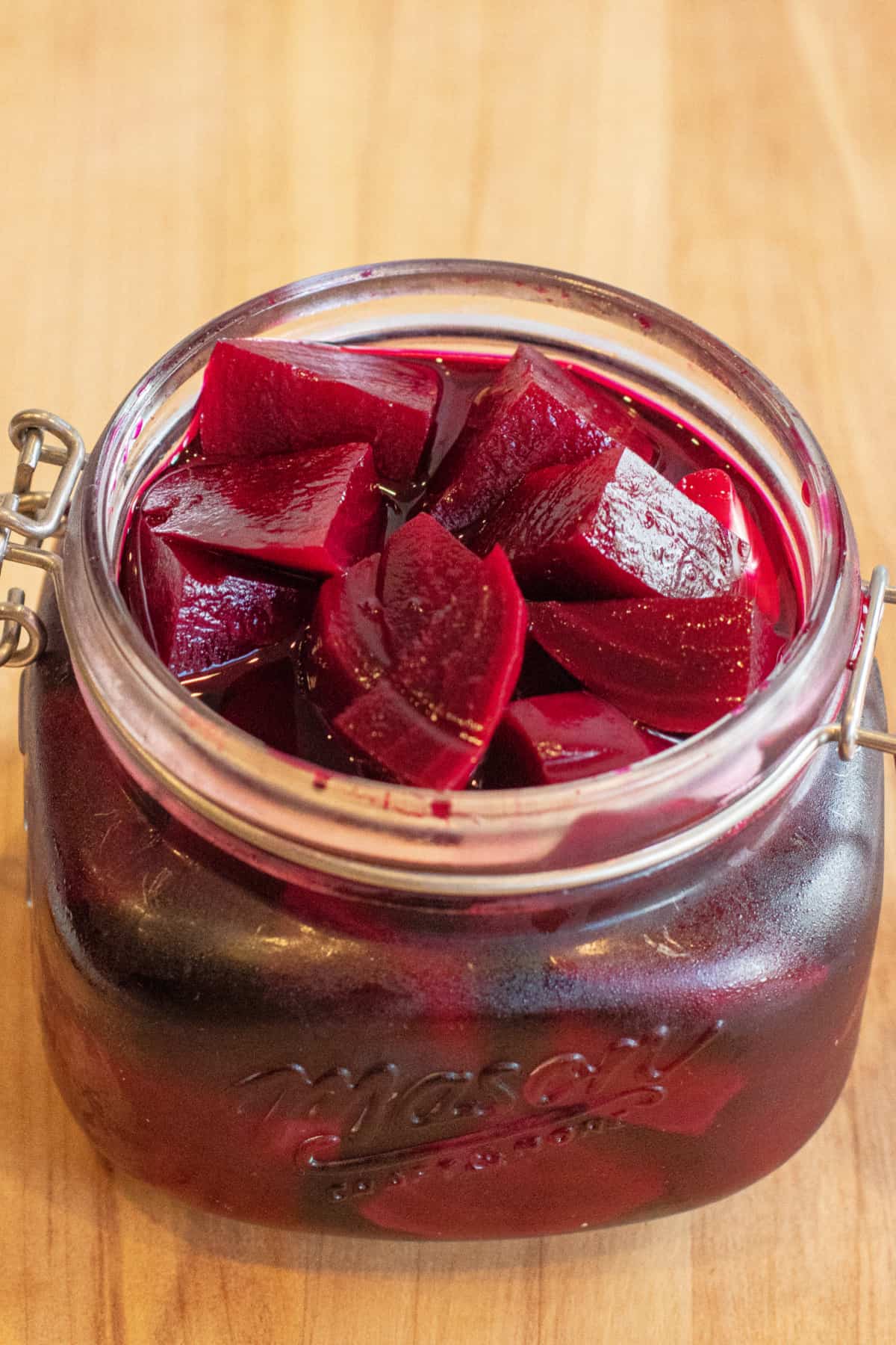 an open mason jar of pickled beets.