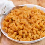 a bowl of creamy pasta with a spoon in it.
