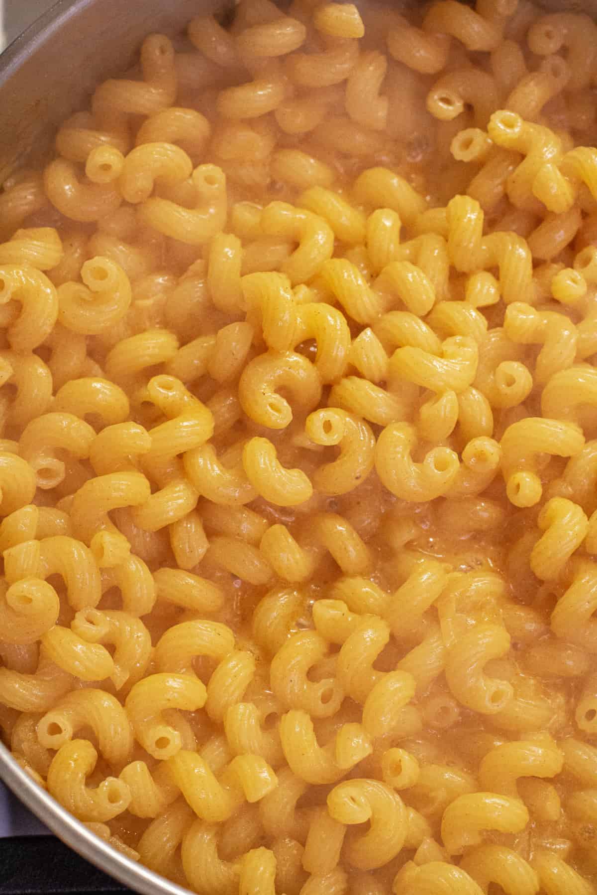 a pan of cooked pasta in a creamy sauce.