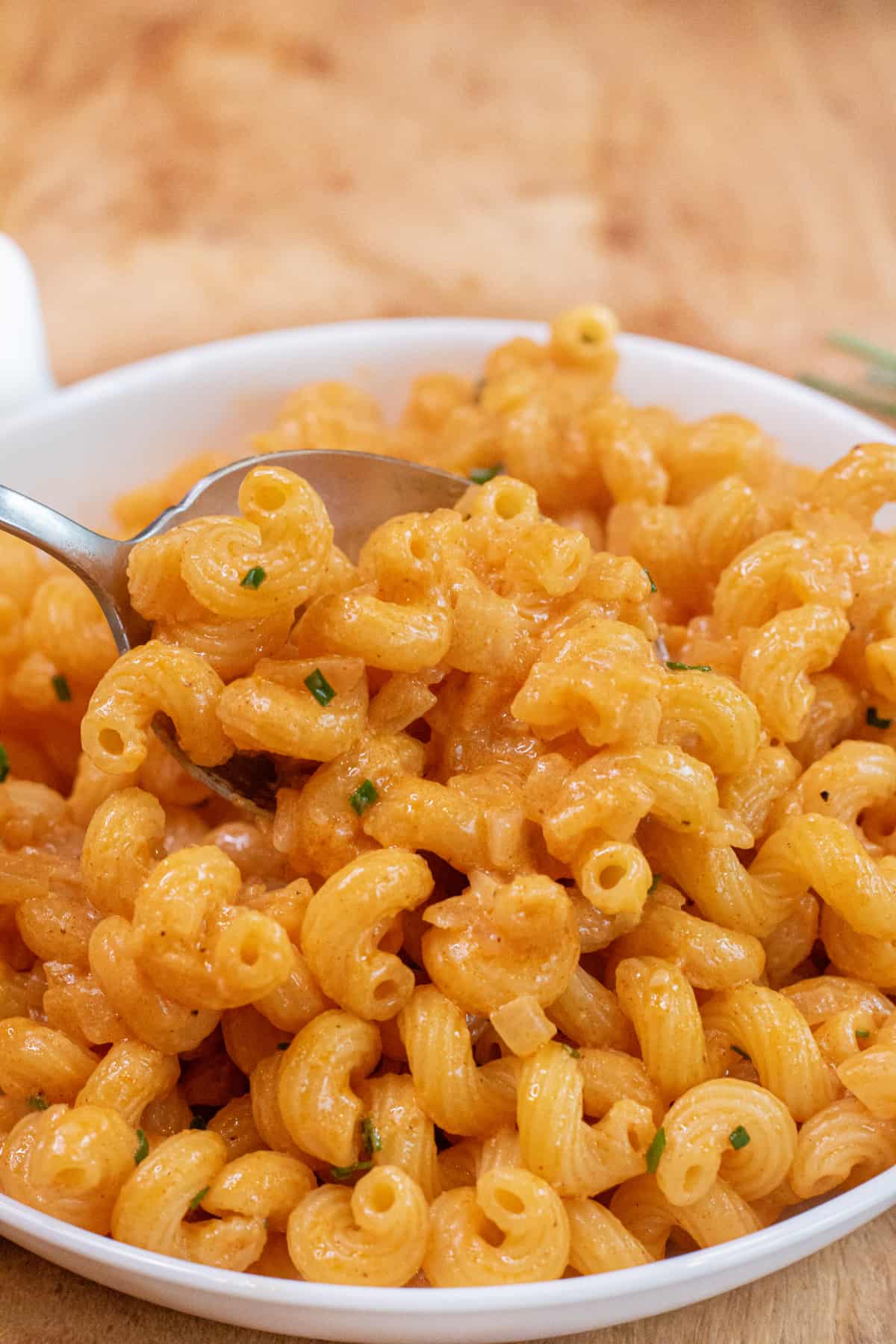 a bowl of creamy pasta with a spoon in it.