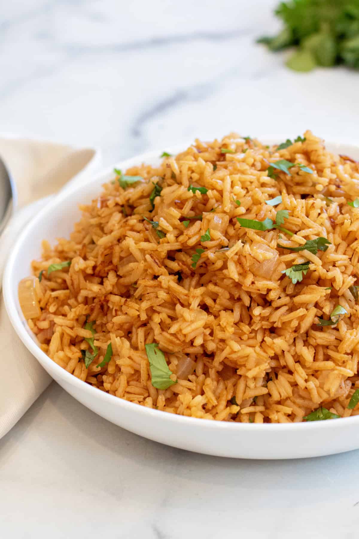 a bowl of fluffy Mexican rice topped with cilantro.