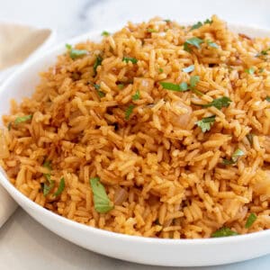 a bowl of fluffy Mexican rice topped with cilantro.