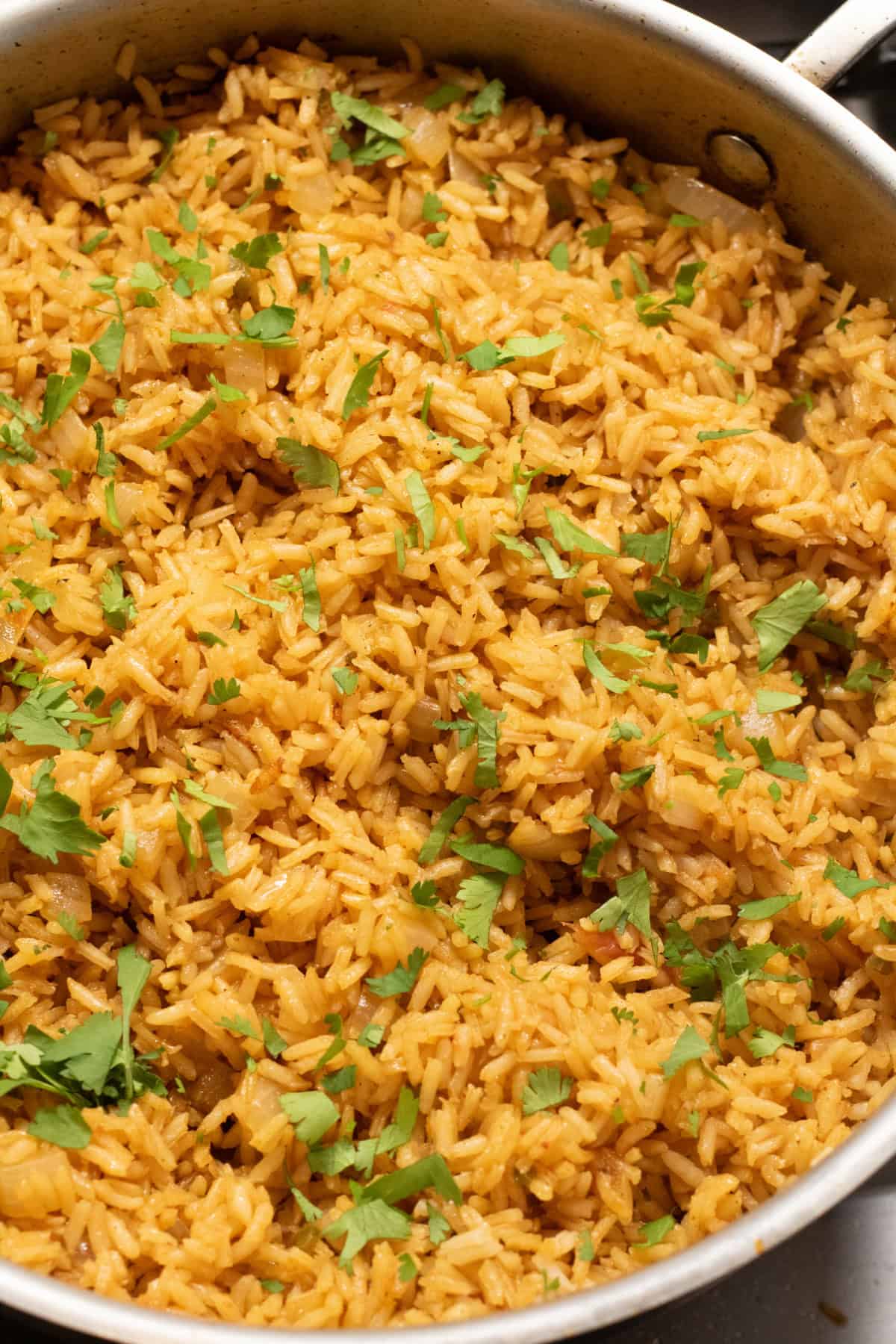 fluffy Mexican Rice in a pan with cilantro.