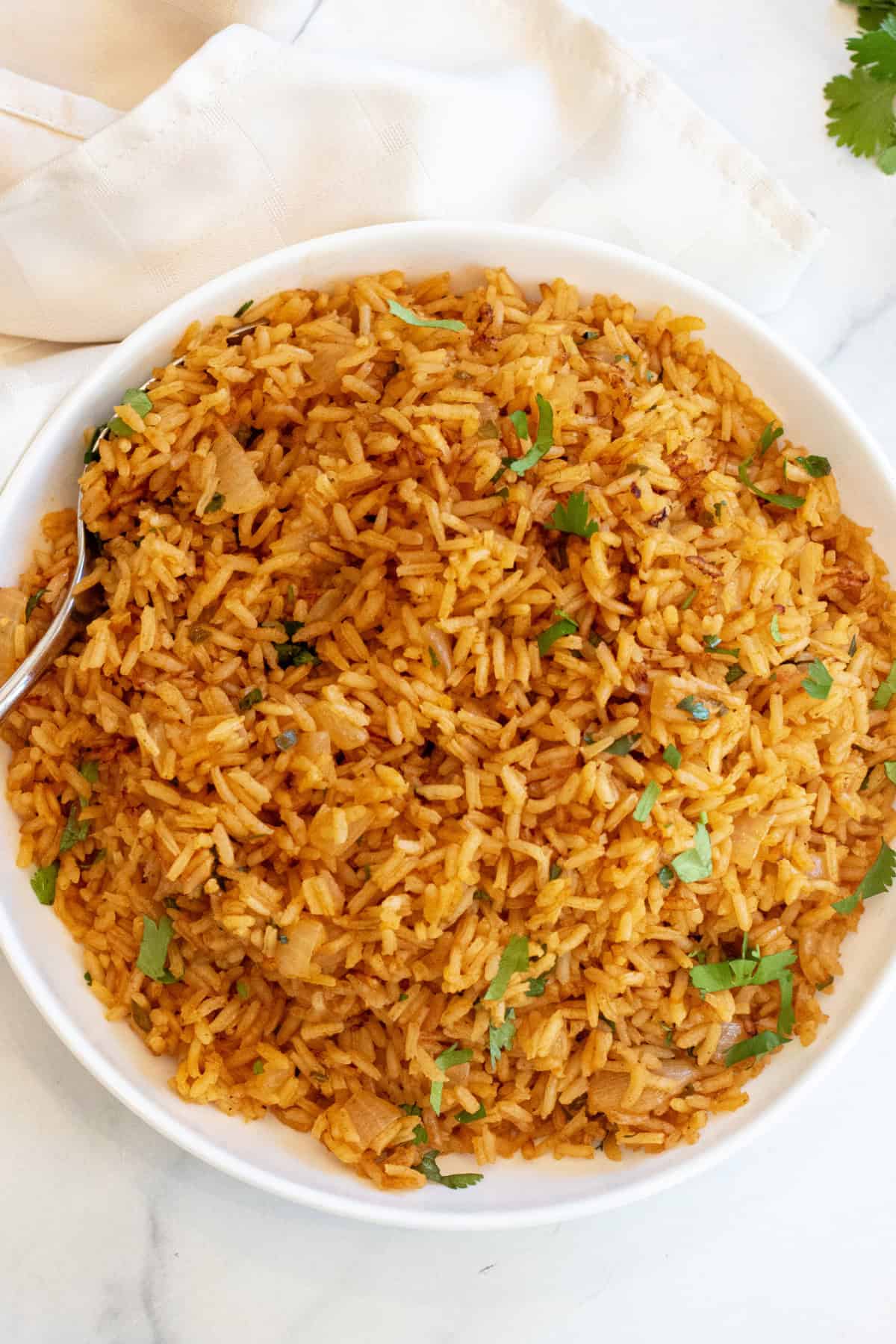 a bowl of fluffy Mexican rice topped with cilantro.