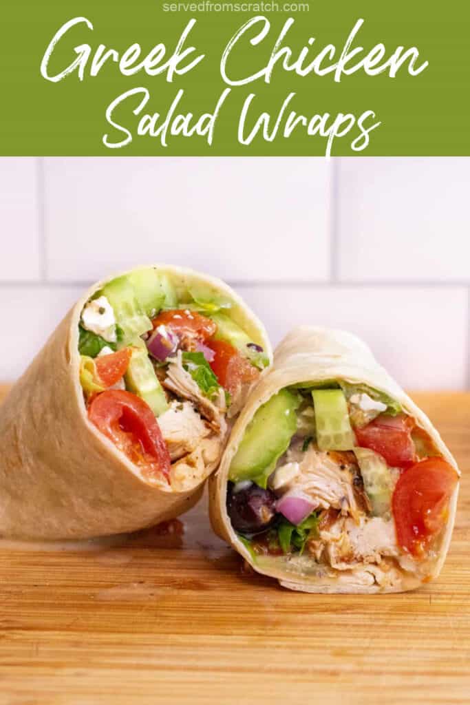 a halved chicken and greek salad wrap on a cutting board with Pinterest pin text.