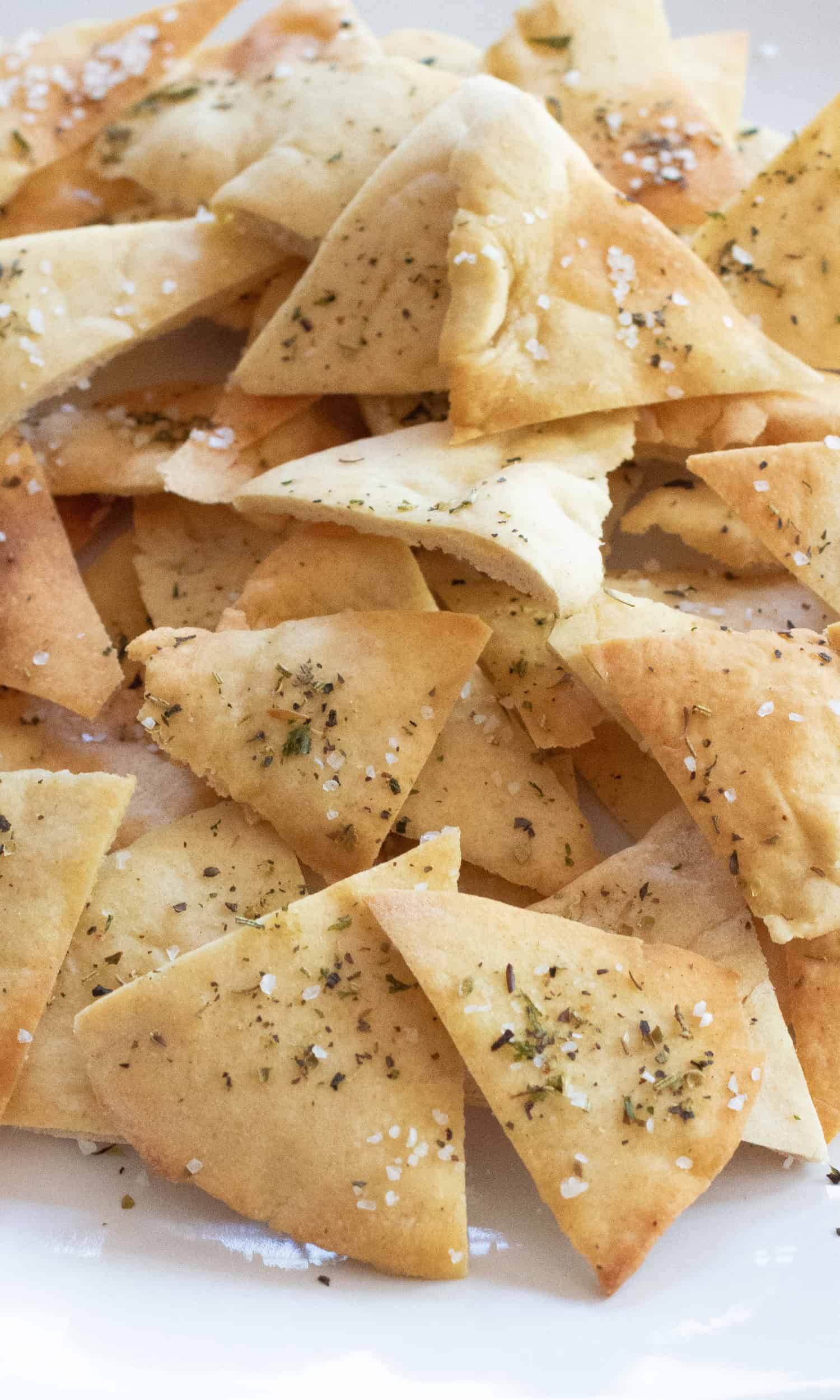 a plate of baked and seasoned and salted pita chips.