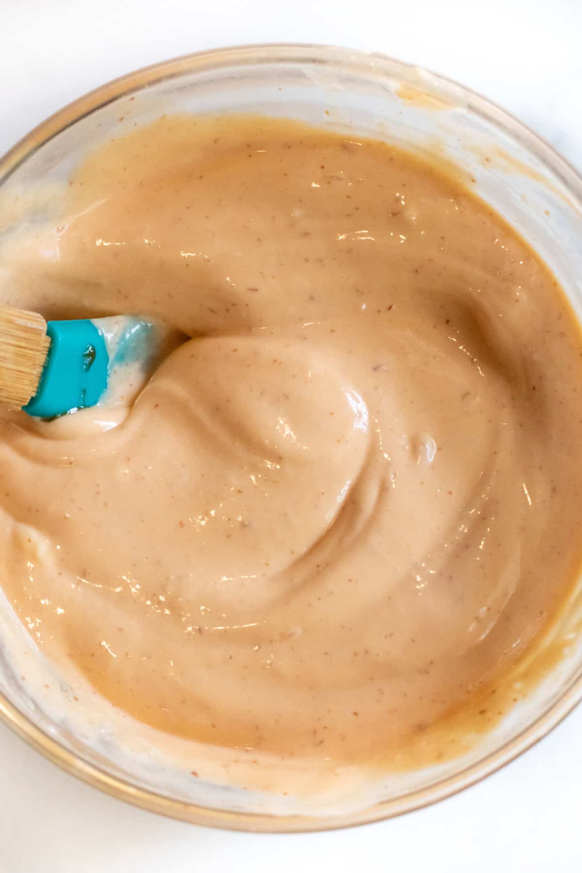 overhead of a bowl of mixed sriracha mayonnaise. 